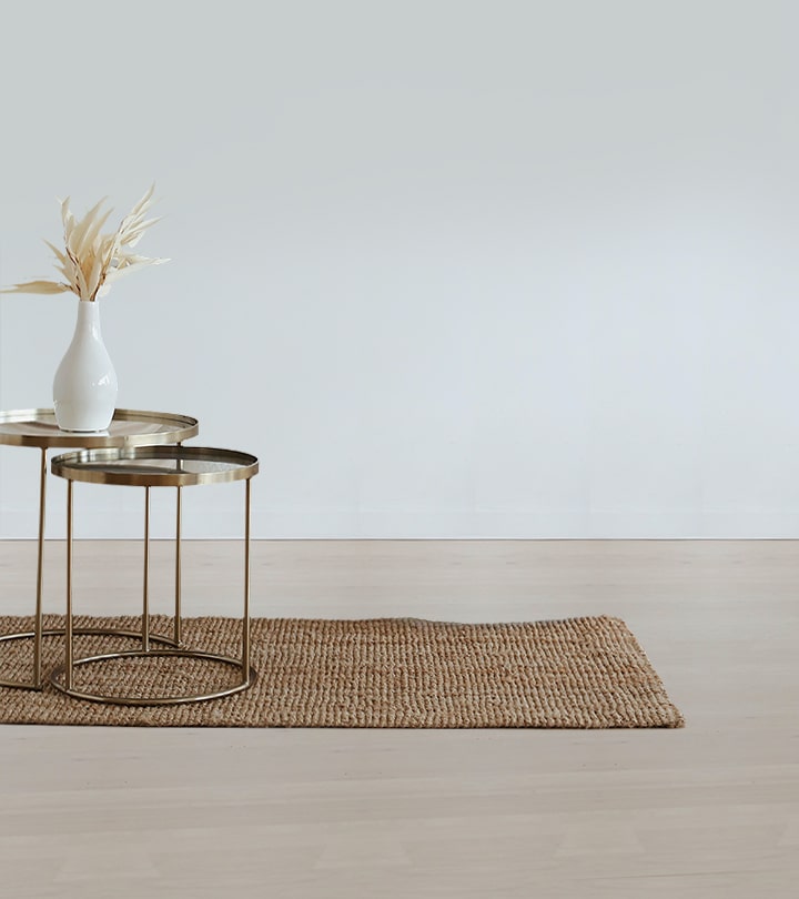 An art deco gold coffee table with a flower vase